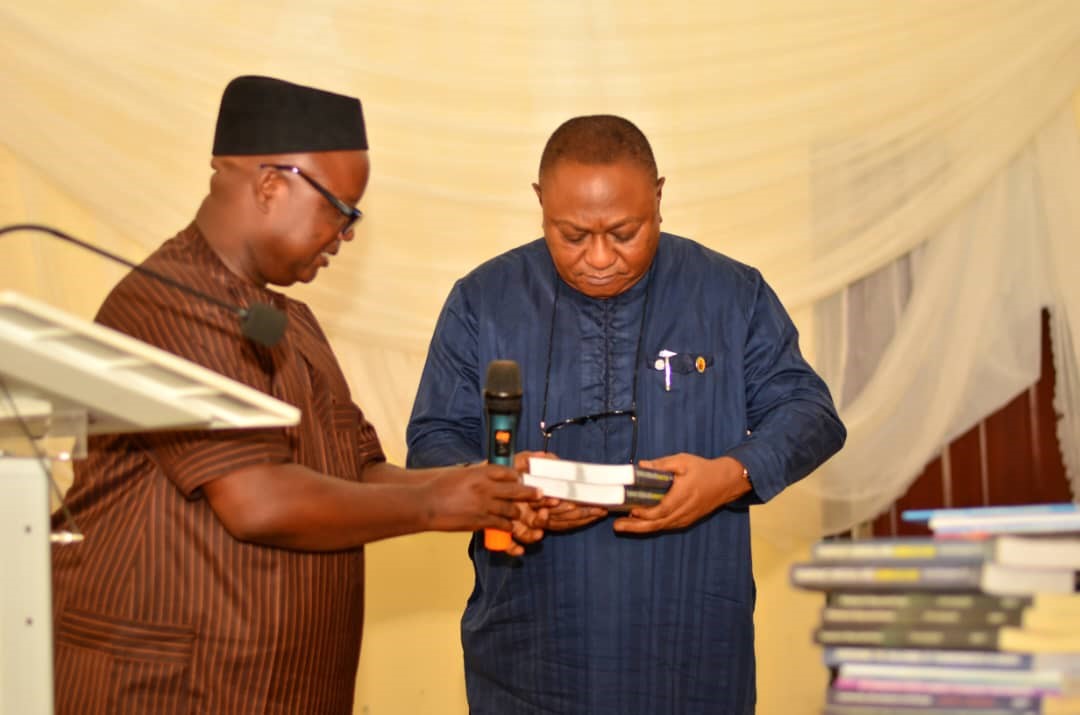 DELSU V-C, Prof. Andy Egwunyenga (Right) receiving a collection of books from the Director of African Centre for Leadership, Strategy and Development, Mr. Monday Osasah at a two-day maiden conference for Gender Directors in Nigerian Universities held